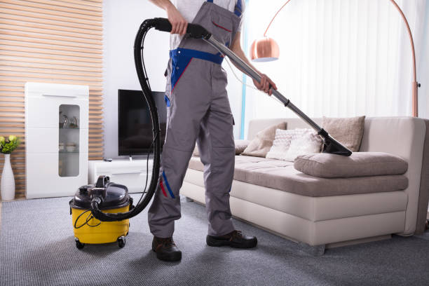 Technician treating a red wine stain on a carpet